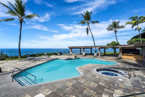 a swimming pool with the ocean in the background at Kanaloa at Keauhou 2002 in Kailua-Kona