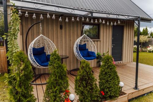 a deck with two chairs and a table at Tiny house Sigulda in Sigulda