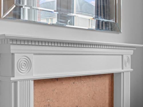a window with a mirror above a fireplace at Mollison 2 Bedroom Apartment - Harthill in Harthill