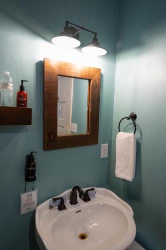 a bathroom with a sink and a mirror at The Groveland Hotel in Groveland