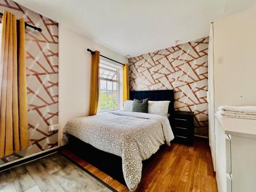 a bedroom with a bed and a window at Rest Boutique Wembley in London