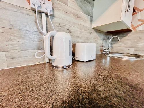 a kitchen with two coffeemakers on a counter at Rest Boutique Wembley in London