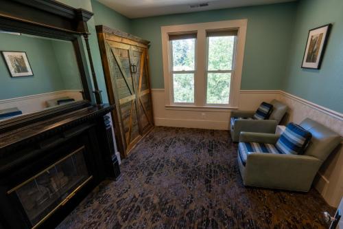 a living room with two chairs and a fireplace at The Groveland Hotel in Groveland