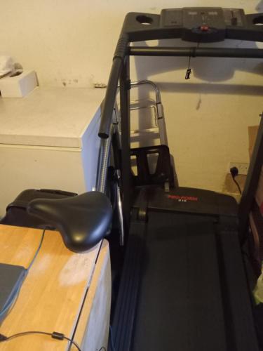 a golf cart with a chair and a table at Your Home Away From Home 4 Mins From Barking Station in Barking