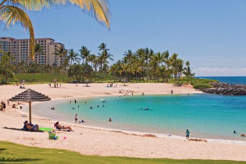 a beach with a bunch of people in the water at Ko Olina Kai 1059F in Kapolei