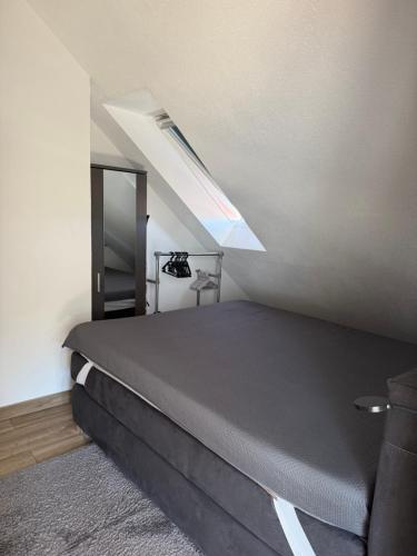 a bedroom with a bed and a stair case at Ruhige zentrale Ferienwohnung in Wolfhagen
