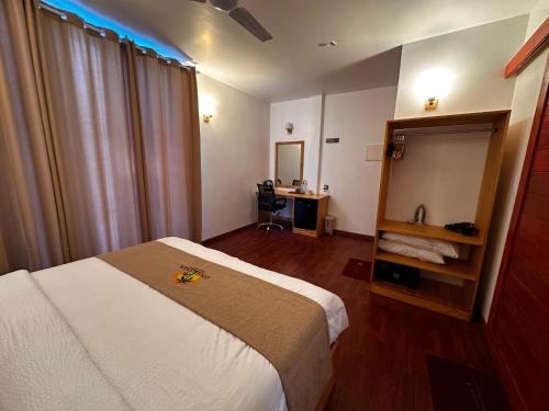 a hotel room with a bed and a desk at Coco Ukulhas Villa in Ukulhas