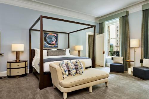 a bedroom with a large bed and a chair at Palace Hotel, a Luxury Collection Hotel, San Francisco in San Francisco