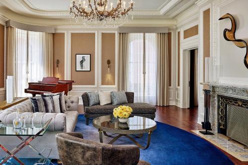 a living room with a couch and a fireplace at Palace Hotel, a Luxury Collection Hotel, San Francisco in San Francisco