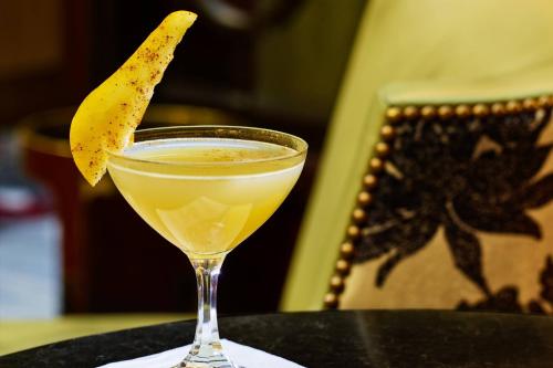 a drink sitting on a table with a banana in it at Palace Hotel, a Luxury Collection Hotel, San Francisco in San Francisco