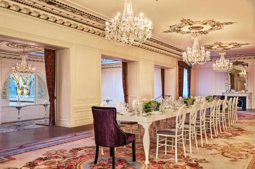a dining room with a table with chairs and chandeliers at Palace Hotel, a Luxury Collection Hotel, San Francisco in San Francisco