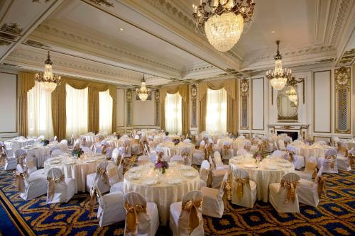 a large banquet hall with white tables and chairs at Palace Hotel, a Luxury Collection Hotel, San Francisco in San Francisco