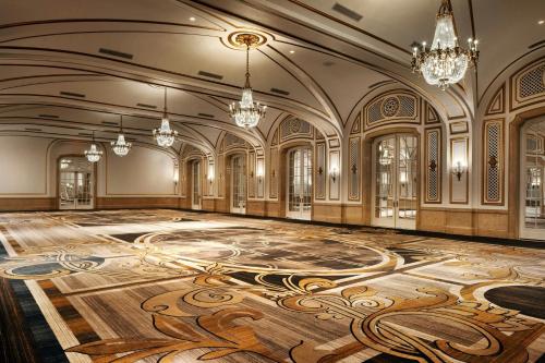 an ornate ballroom with a wooden floor and chandeliers at Palace Hotel, a Luxury Collection Hotel, San Francisco in San Francisco