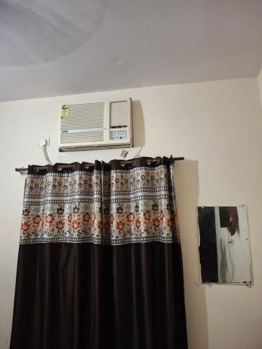a room with a air conditioner on top of a curtain at Hotel Kanhaiya Inn in Haridwār