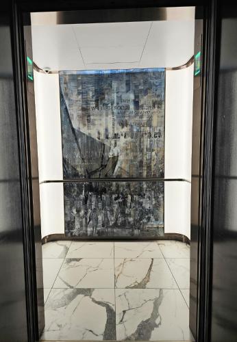 a view through a glass door of a painting at Yorkville's Premier 2-Bedroom, 2-Bath Suite in Toronto