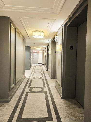 a corridor of an office building with a long hallway at Elegant 2BR & 2BA Retreat in Prime Yorkville, Downtown in Toronto
