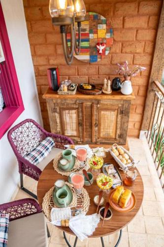 a table with food on it in a room at Chafariz Por Um Triz Pousada de Charme in Tiradentes