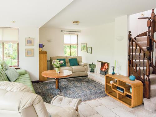 a living room with a couch and a fireplace at Middle Lodge in Mintlaw