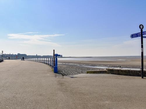 a beach with a blue fence next to the ocean at Sand Dune - Uk48699 in Lancaster