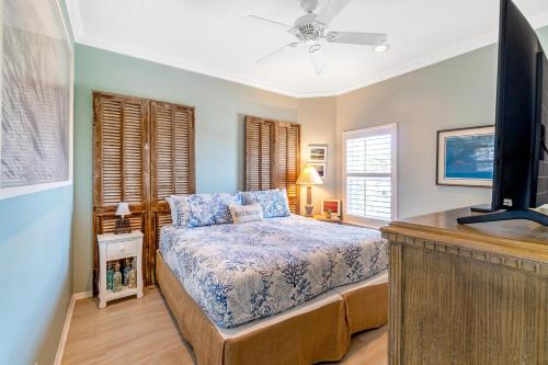 a bedroom with a bed and a flat screen tv at Blue Angel, Blue Angel -Gulf Front, Beautiful Views! Great for Families! in Pensacola Beach