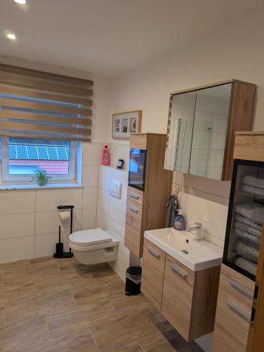 a bathroom with a toilet and a sink at Bauers Ferienwohnung in Wabern