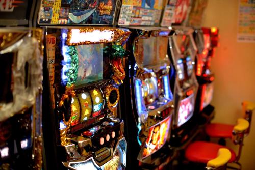 a row of slot machines in a room at Capsule&Spa Grand Sauna Shinsaibashi in Osaka