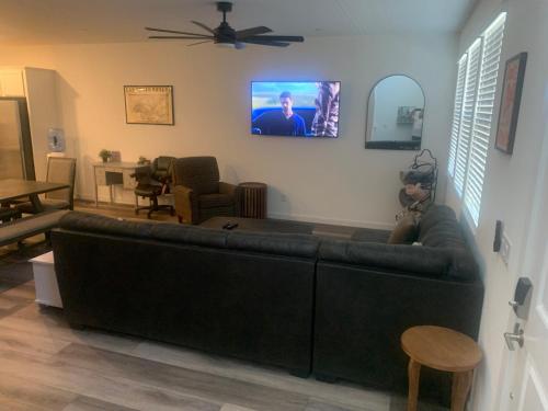 a living room with a couch and a flat screen tv at Walking on Water Street in Las Vegas