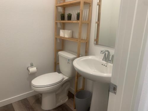 a bathroom with a toilet and a sink at Walking on Water Street in Las Vegas