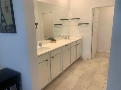 a bathroom with two sinks and a mirror at Walking on Water Street in Las Vegas
