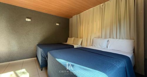 a room with two beds in a hotel room at LA Green Sunset in João Pessoa