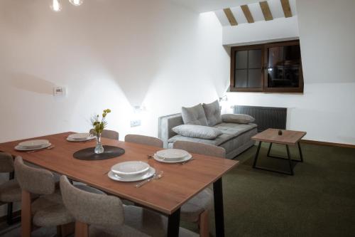 a living room with a table and a couch at Angelina Apart Hotel&Spa in Divčibare