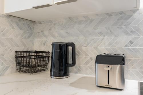 a coffeemaker and coffee maker on a kitchen counter at Shore Breeze in Toronto