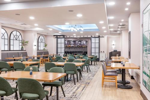 a dining room with tables and chairs and a bar at Crowne Plaza Kansas City Downtown by IHG in Kansas City