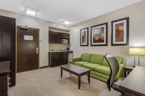 a living room with a couch and a table at Best Western Wainwright Inn & Suites in Wainwright