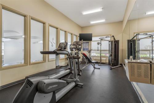 a gym with treadmills and ellipticals in a building at Best Western Wainwright Inn & Suites in Wainwright