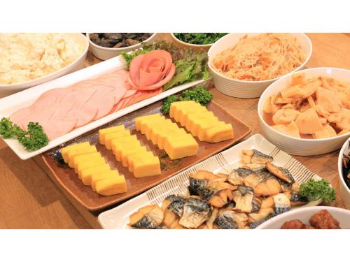 a table topped with different types of cheese and other foods at Smile Hotel Kawaguchi - Vacation STAY 05018v in Kawaguchi