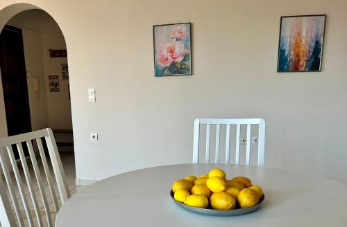 a bowl of lemons sitting on a white table at Lemon & Light 