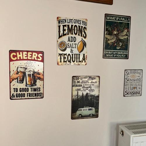 a wall with a bunch of posters on it at Lemon & Light 
