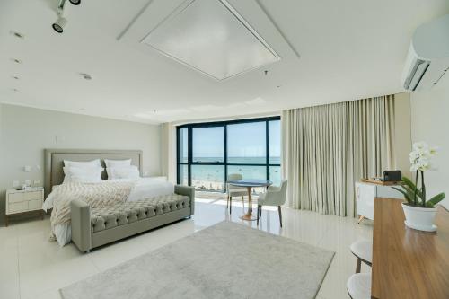 a bedroom with a bed with a view of the ocean at Meridiano Hotel in Maceió