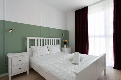 En eller flere senge i et værelse på Sika Winn Premium Apartment- private parking