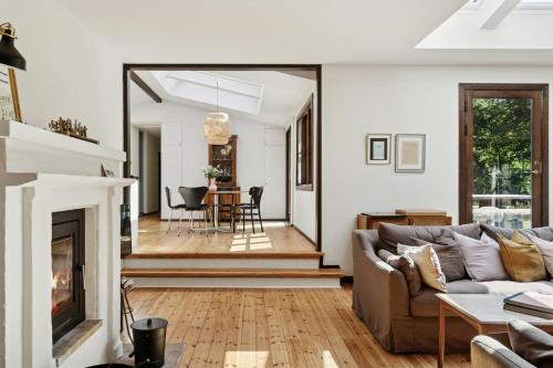 a living room with a couch and a fireplace at Architect Designed With Two Wings By Tisvilde Hegn in Tisvildeleje