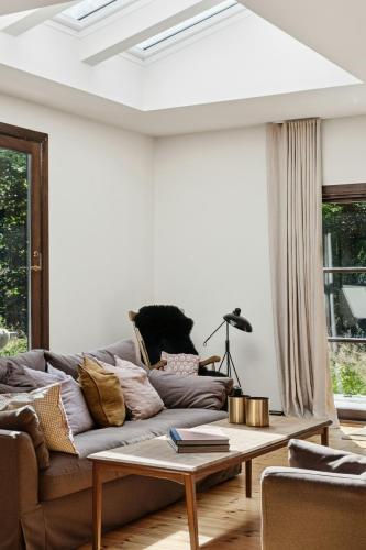 a living room with a couch and a coffee table at Architect Designed With Two Wings By Tisvilde Hegn in Tisvildeleje