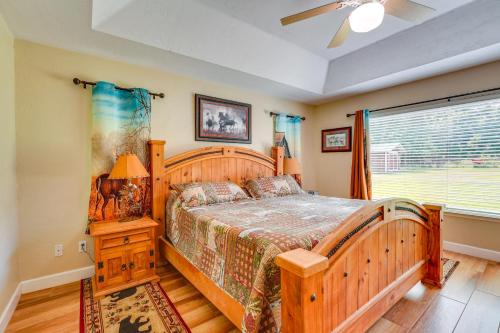 a bedroom with a wooden bed and a window at Welcoming Home with Yard on 20 Acres in High Springs in High Springs