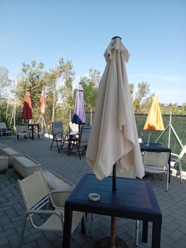 a white umbrella on a table on a patio at Bio Fattoria Mula D'Oro - biofattoriamuladoro it - Organic Food, Nature & Relax in Mulazzano