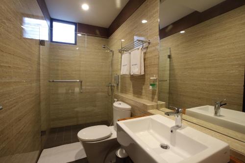 a bathroom with a sink and a toilet and a shower at Dago Teuku Angkasa 14 in Bandung