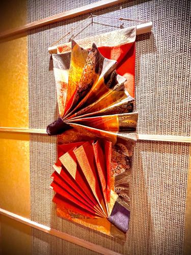 a display of different colored umbrellas on a shelf at 宿坊長運寺 in Hayama