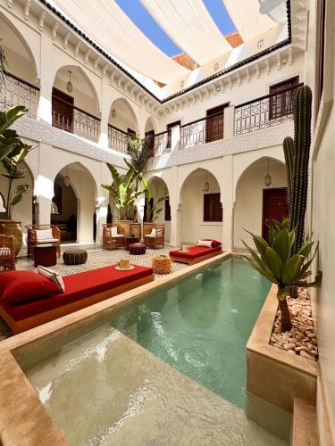 a large room with a pool in a building at Riad Dar Melia in Marrakesh