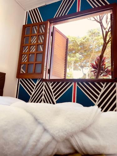 a bedroom with a large window and a bed at Hospedaria São Jorge in Sao Jorge