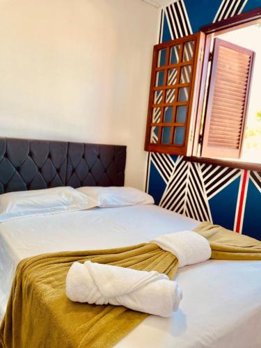 a bedroom with two beds with towels on them at Hospedaria São Jorge in Sao Jorge
