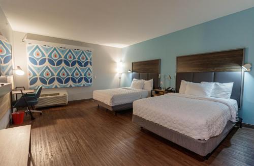 a hotel room with two beds and a desk at Tru by Hilton in McKinney